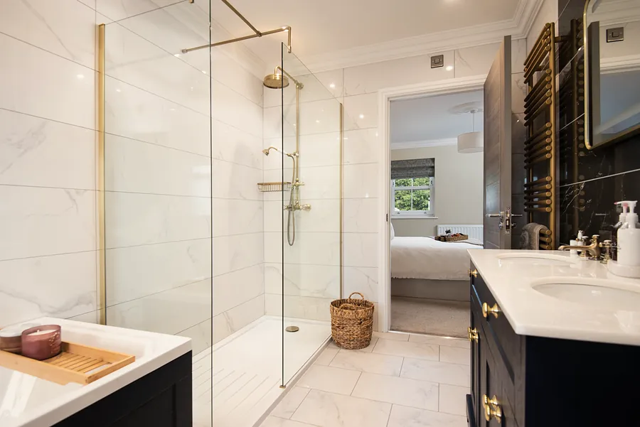 Bathroom with a walk-in shower and brass fittings